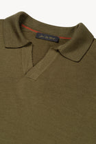 Detail of The Observer long-sleeve knitted polo in extra-fine merino wool, showing the buttonless open collar in Dark Olive
