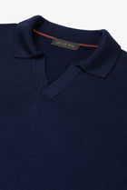 Detail of The Observer long-sleeve knitted polo in extra-fine merino wool, showing the buttonless open collar in Ink Navy.