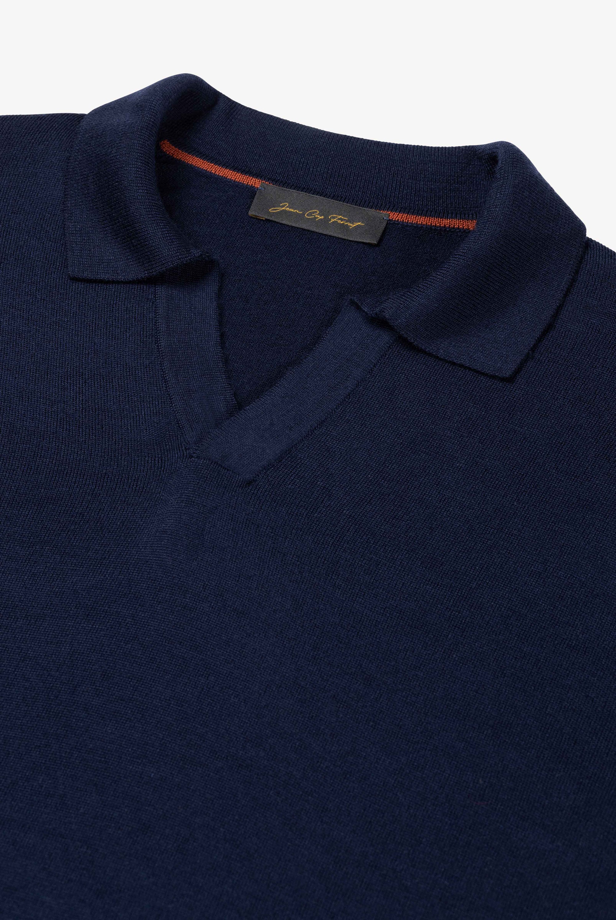Detail of The Observer long-sleeve knitted polo in extra-fine merino wool, showing the buttonless open collar in Ink Navy.