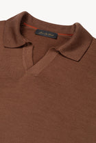 Detail of The Observer long-sleeve knitted polo in extra-fine merino wool, showing the buttonless open collar in Umber Brown
