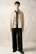 The Observer long-sleeve knitted polo in extra-fine merino wool, shown in Dark Olive, full body styled look on model
