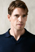 The Observer long-sleeve knitted polo in extra-fine merino wool, shown in Ink Navy, upper body view on model.
