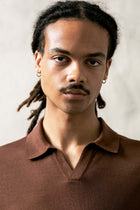 The Observer long-sleeve knitted polo in extra-fine merino wool, shown in Umber Brown, upper body view on model
